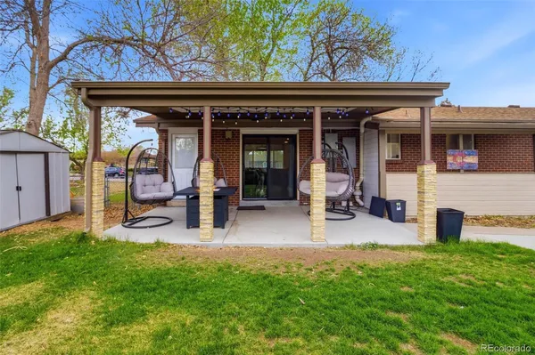 a house view with a sitting space and garden