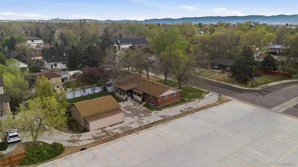 an aerial view of a residential house with a yard and lake view