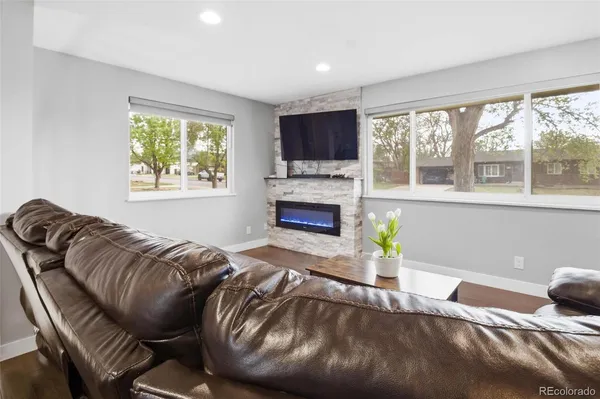 a living room with furniture and a fireplace
