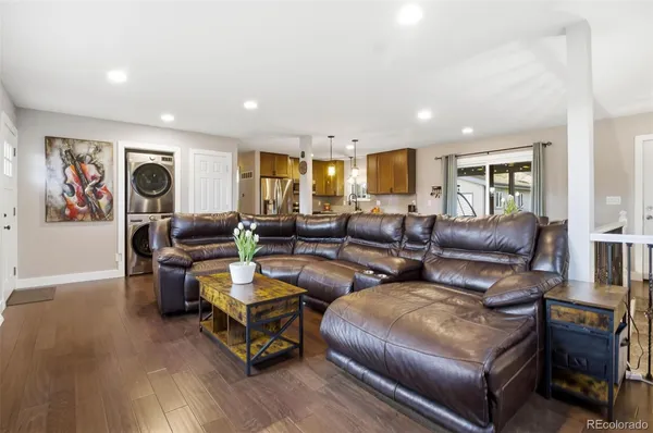 a living room with furniture and a wooden floor