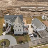 an aerial view of a house with swimming pool and ocean view