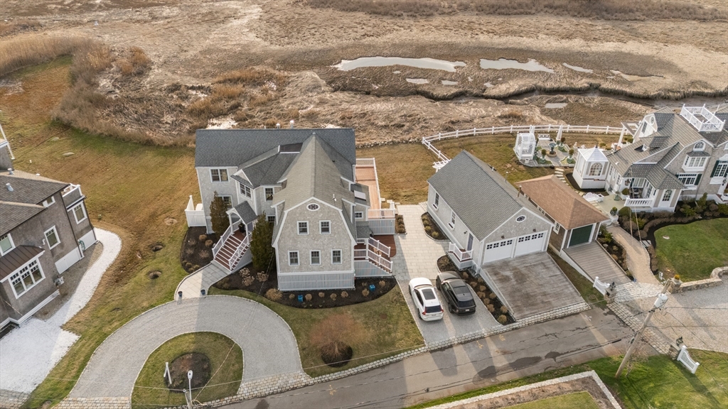an aerial view of a house with swimming pool and ocean view