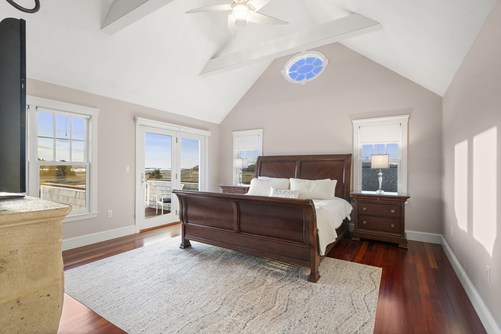 35 Bayberry Road Scituate, MA 02066 - Photo 19 of 39 a bedroom with a bed and a table with wooden floor