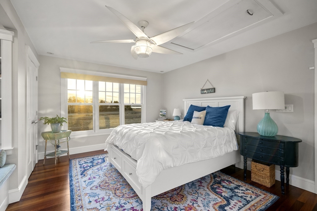 35 Bayberry Road Scituate, MA 02066 - Photo 24 of 39 a large bedroom with a bed wooden floor and a table