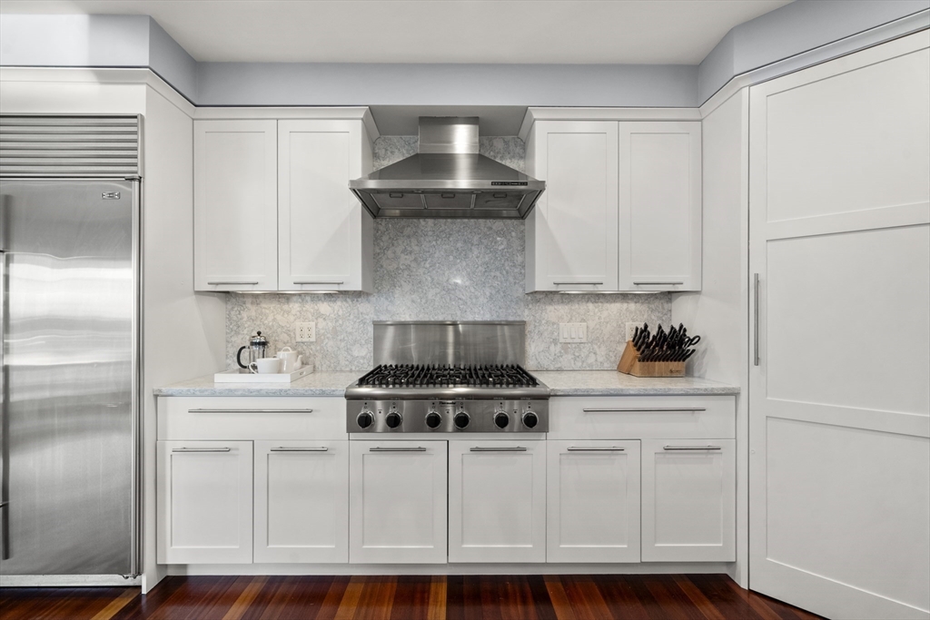 35 Bayberry Road Scituate, MA 02066 - Photo 4 of 39 a kitchen with white cabinets and white appliances