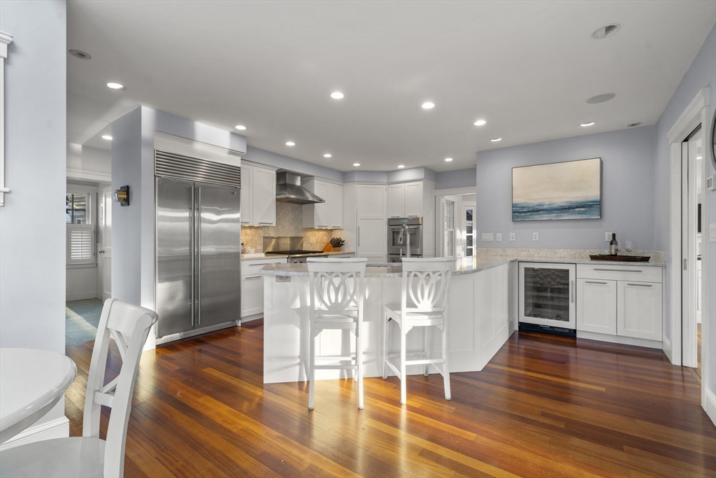 35 Bayberry Road Scituate, MA 02066 - Photo 7 of 39 a open kitchen with white cabinets and stainless steel appliances
