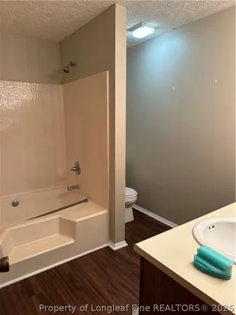 a bathroom with a sink a toilet and bathtub