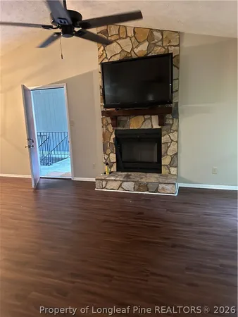 a view of a living room with hardwood floor and a flat screen tv