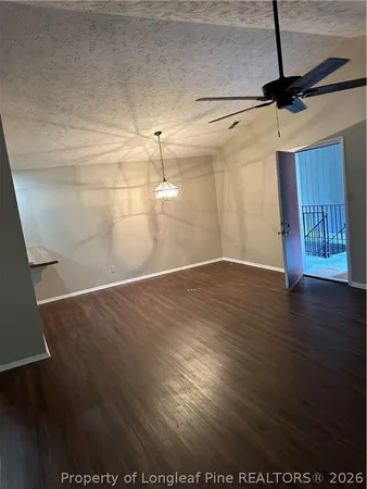 a view of a room with wooden floor