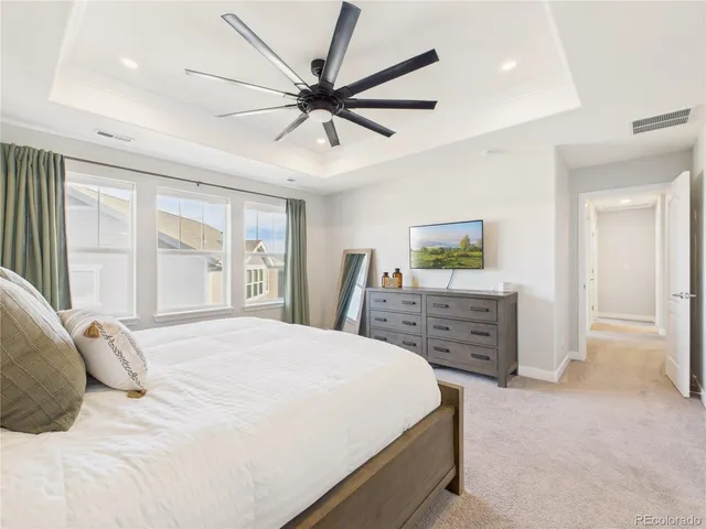 a bedroom with a large bed and a chandelier