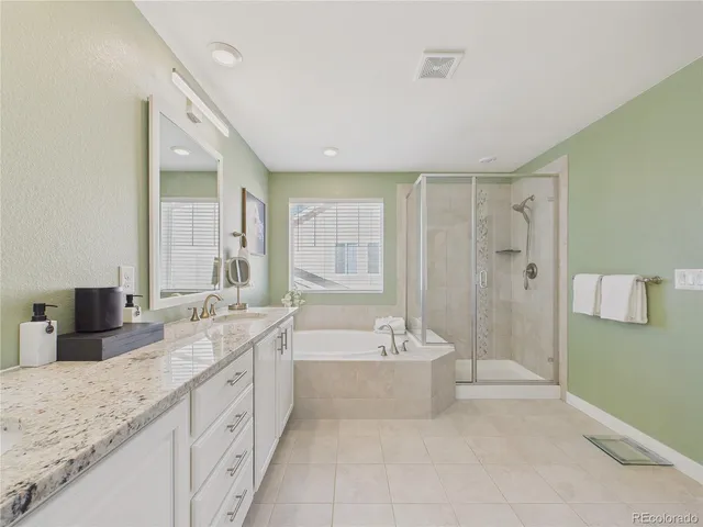 a spacious bathroom with a double vanity sink tub double and mirror
