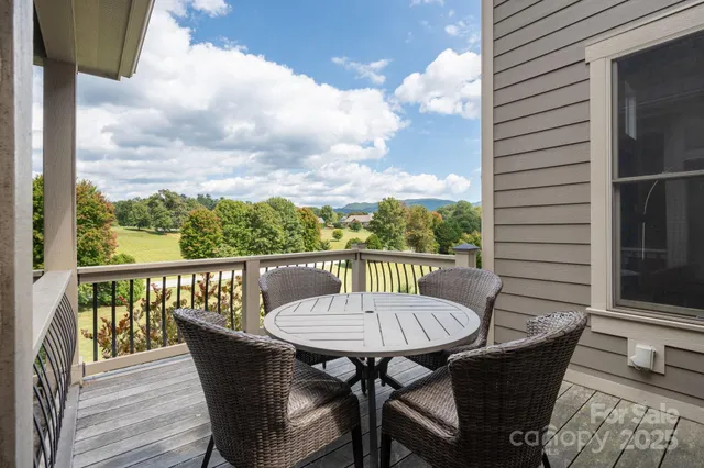 a living room with furniture and floor to ceiling windows