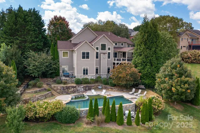 a aerial view of a house with a yard table and chairs
