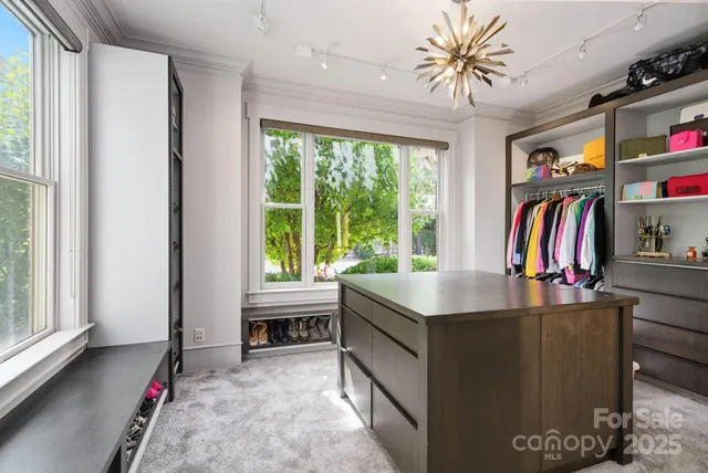 a bedroom with a large bed and a flat tv screen on dresser