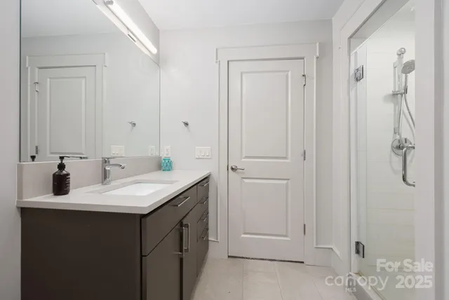 a view of swimming pool with outdoor seating and trees in the background