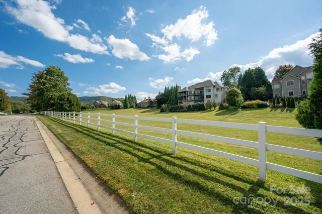 a view of a fence and trees