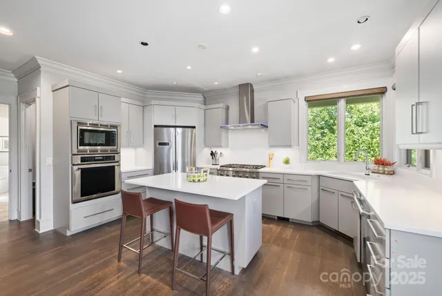 a kitchen with a stove a refrigerator and a sink