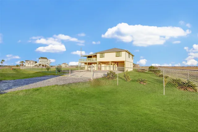 a backyard of a house with table and chairs