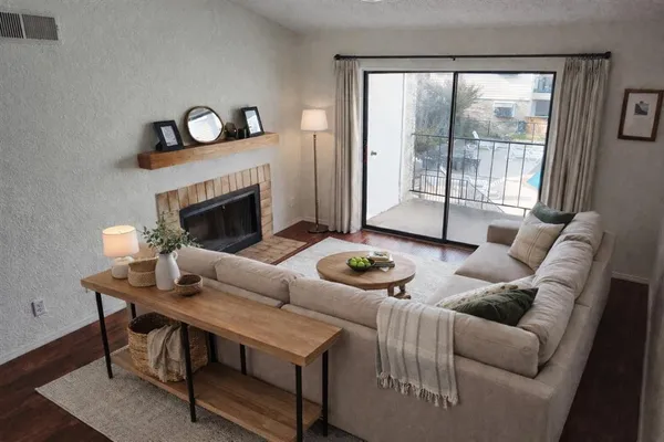 a living room with furniture and a fireplace