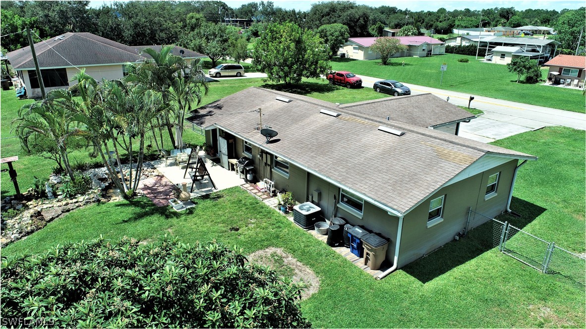 12 Massachusetts Road Lehigh Acres, FL 33936 - Photo 24 of 30 an aerial view of a house having yard and a patio