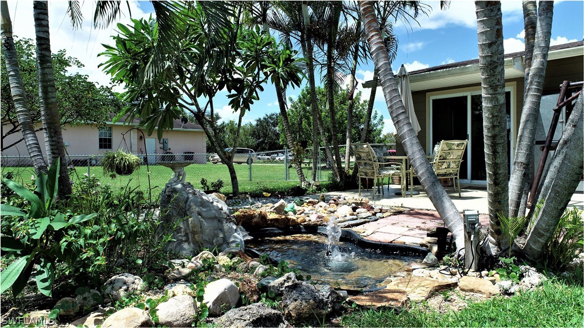 12 Massachusetts Road Lehigh Acres, FL 33936 - Photo 29 of 30 a view of a backyard with sitting area and garden