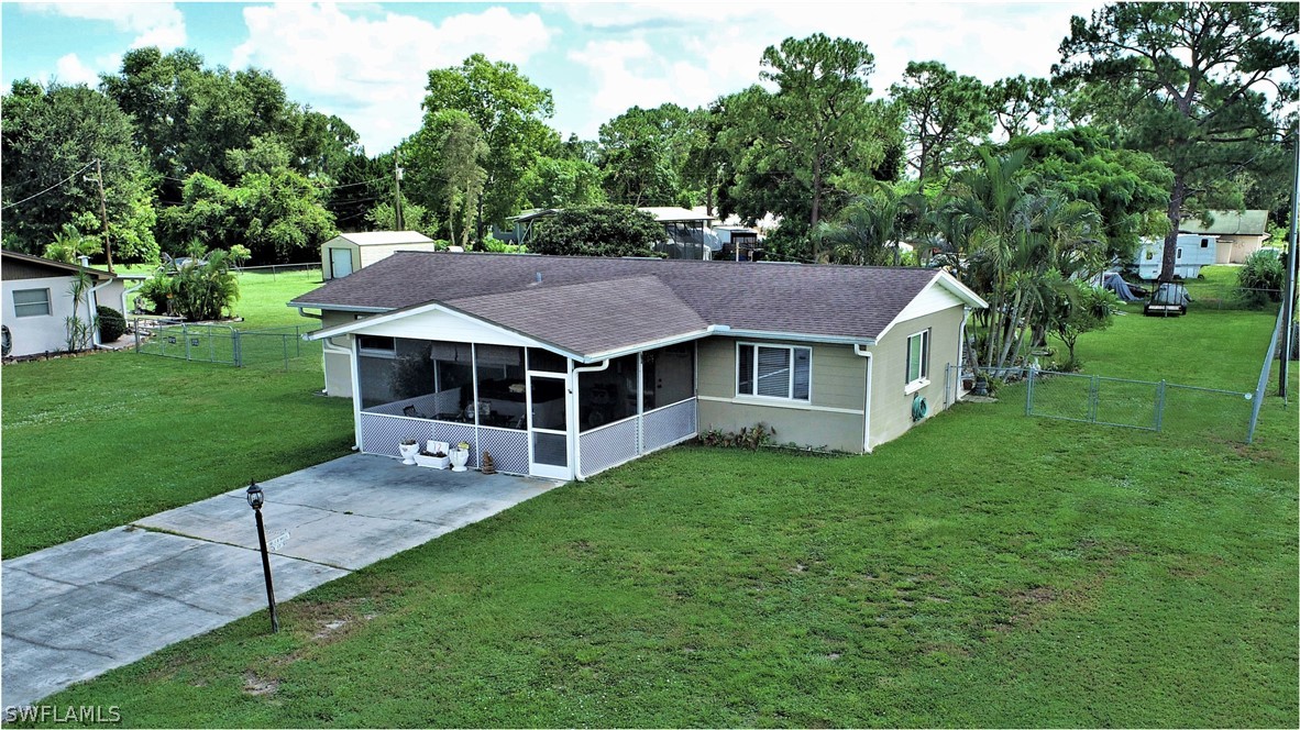 12 Massachusetts Road Lehigh Acres, FL 33936 - Photo 3 of 30 a aerial view of a house with a yard table and chairs