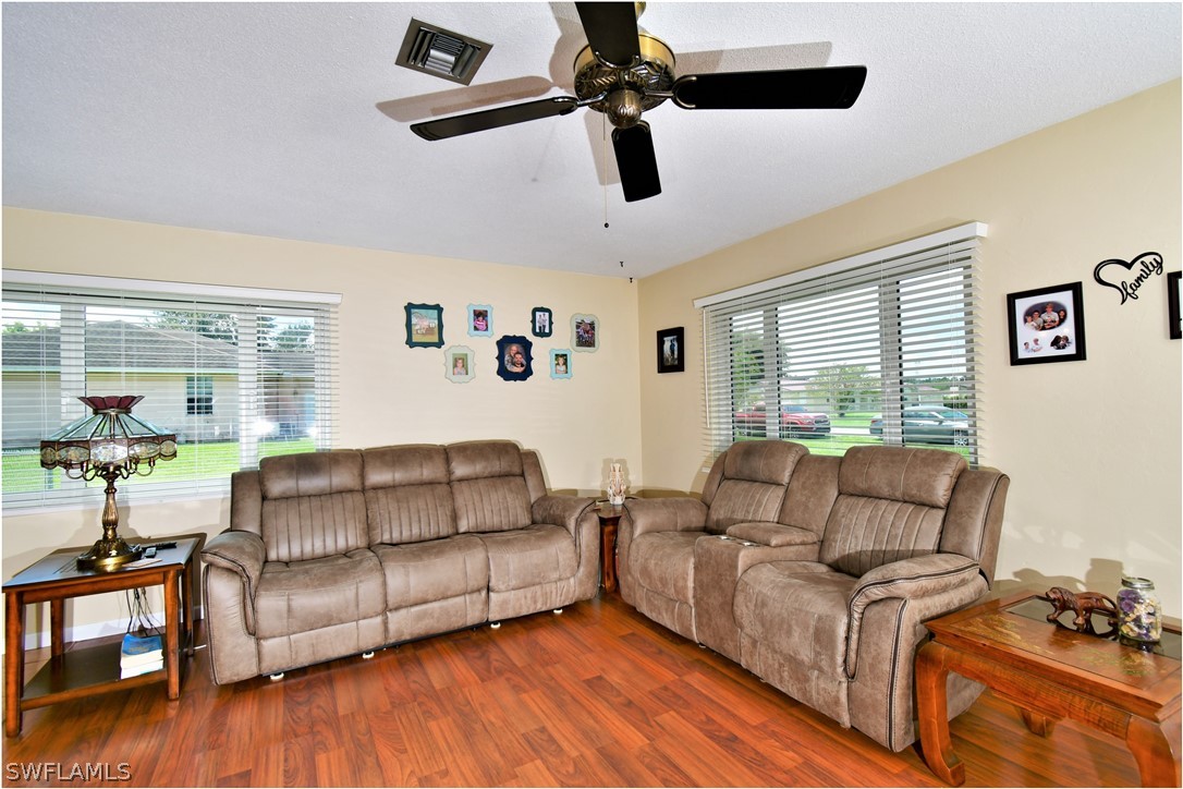 12 Massachusetts Road Lehigh Acres, FL 33936 - Photo 9 of 30 a living room with furniture and a window