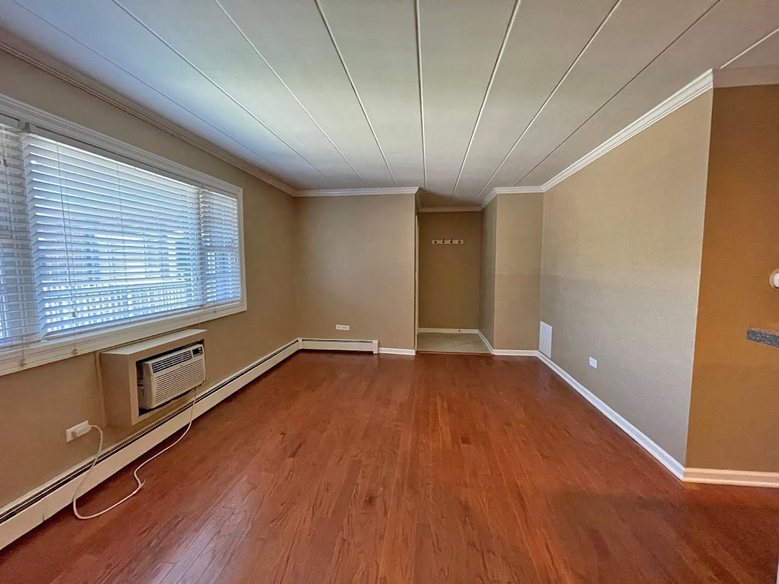 454 Spring Road, Unit 13 Elmhurst, IL 60126 - Photo 3 of 15 wooden floor in an empty room with a window