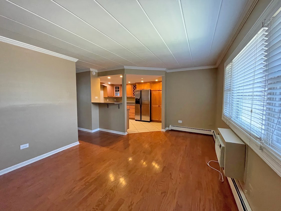 454 Spring Road, Unit 13 Elmhurst, IL 60126 - Photo 4 of 15 an empty room with a fireplace and windows