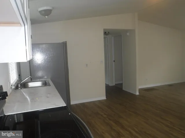 a view of a workspace with wooden floor