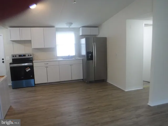 a kitchen with stainless steel appliances granite countertop a refrigerator sink and stove