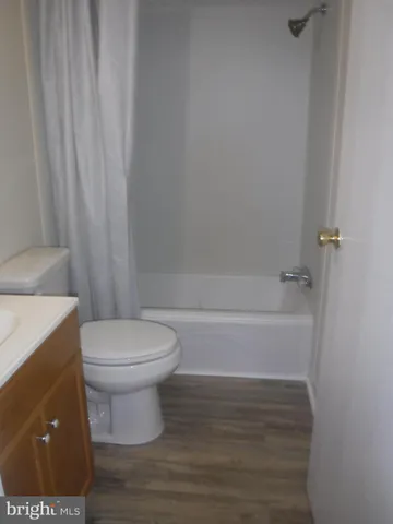 a bathroom with a toilet and a shower curtain