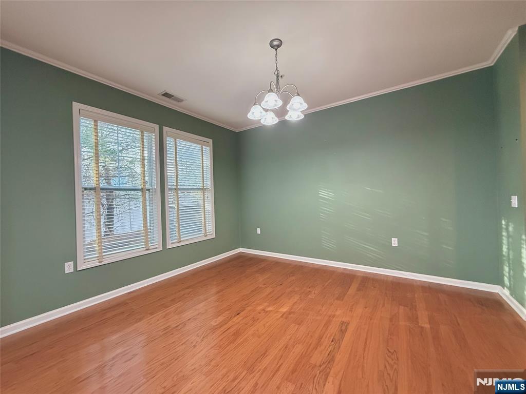 401 River Place Butler, NJ 07405 - Photo 11 of 42 an empty room with wooden floor and windows