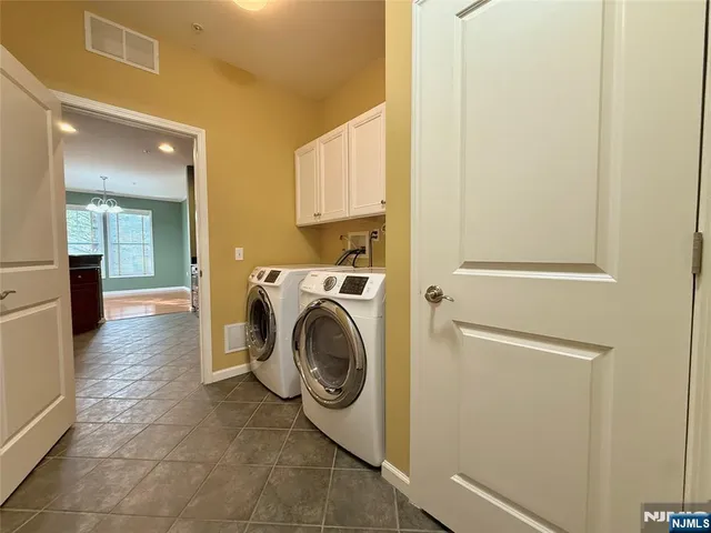 a view of a hallway with washer and dryer