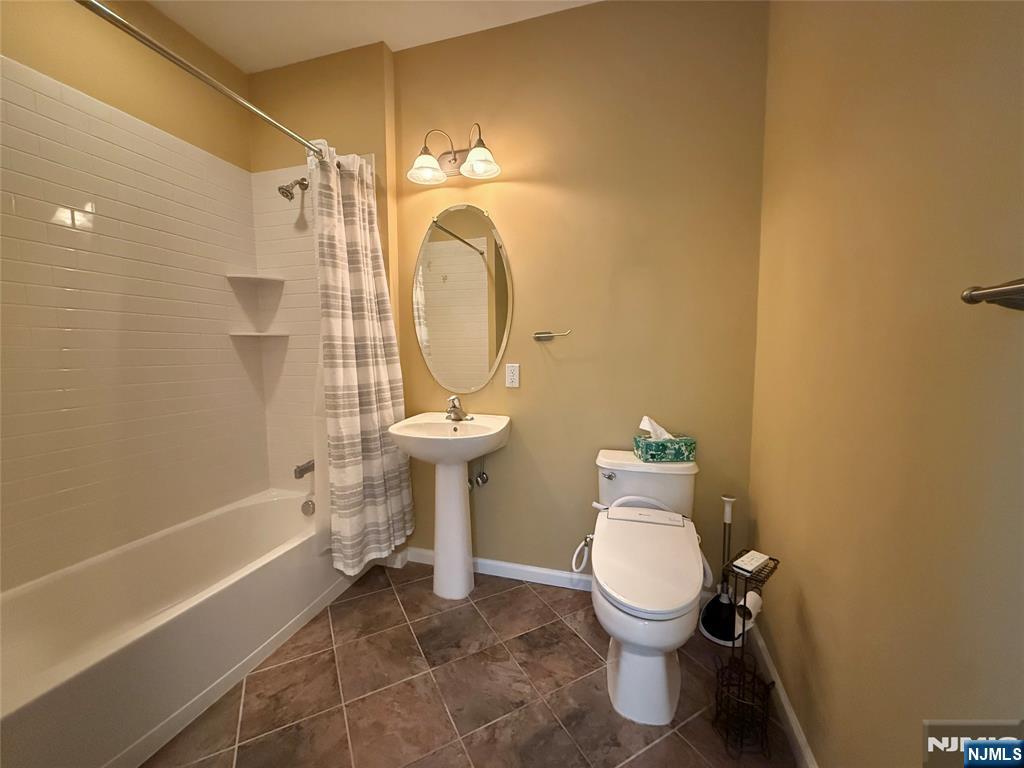 401 River Place Butler, NJ 07405 - Photo 22 of 42 a bathroom with a toilet sink and shower