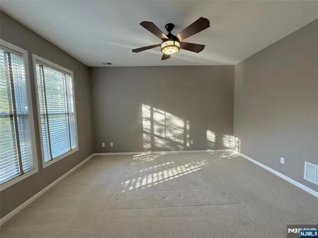 a large spacious bathroom with a tub double sink window and mirror