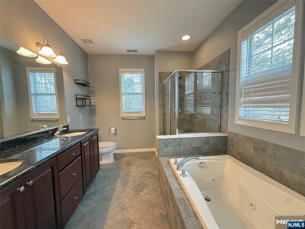 401 River Place Butler, NJ 07405 - Photo 27 of 42 a large spacious bathroom with a tub double sink window and mirror