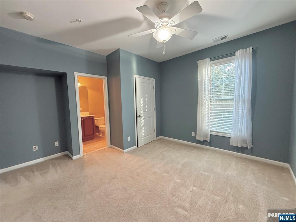 401 River Place Butler, NJ 07405 - Photo 32 of 42 an empty room with closet and a ceiling fan