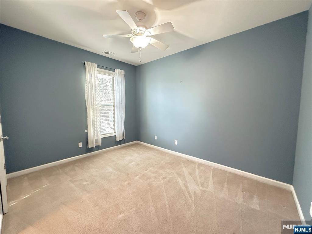 401 River Place Butler, NJ 07405 - Photo 34 of 42 a view of an empty room with a window