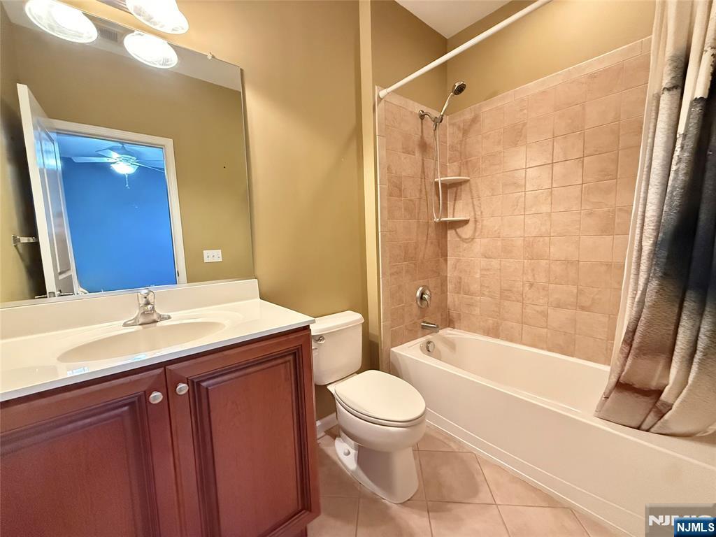 401 River Place Butler, NJ 07405 - Photo 35 of 42 a bathroom with a granite countertop sink toilet and shower