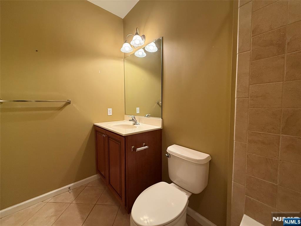 401 River Place Butler, NJ 07405 - Photo 36 of 42 a bathroom with a toilet a sink and mirror