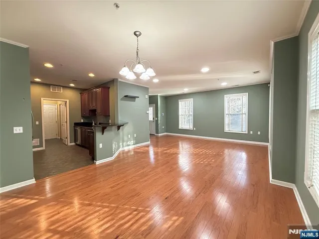 a view of livingroom and kitchen with chandelier