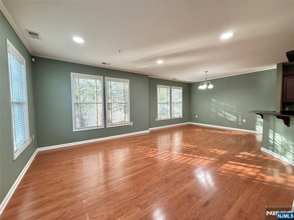 401 River Place Butler, NJ 07405 - Photo 7 of 42 a view of empty room with wooden floor and fan