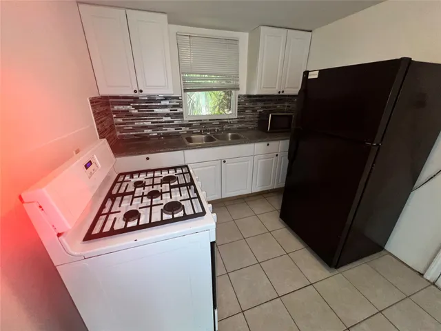 a kitchen with stainless steel appliances a refrigerator and a stove