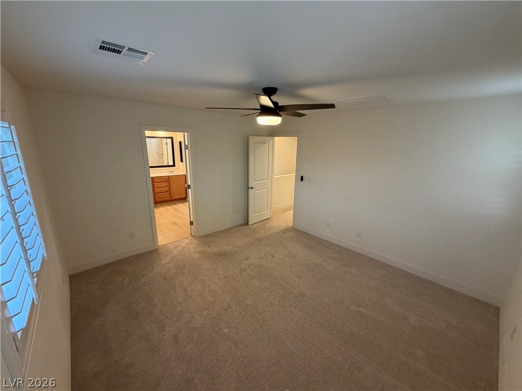 7879 Shoreline Ridge Court Las Vegas, NV 89166 - Photo 10 of 26 A spacious layout and neutral carpeting define this inviting bedroom space.