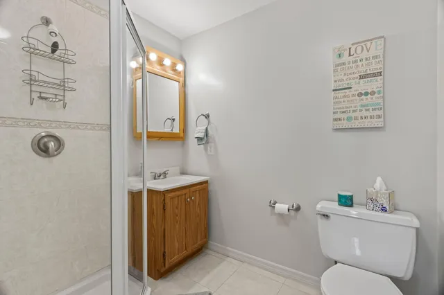 a bathroom with a toilet a sink and mirror