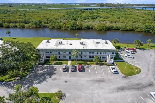 an aerial view of a house with a lake view