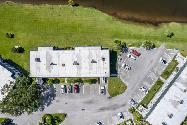 an aerial view of a house with a swimming pool and outdoor seating