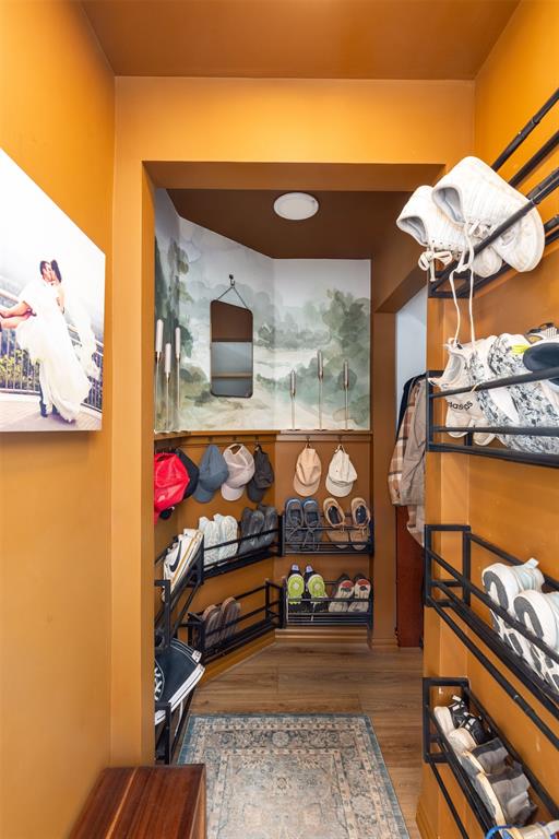 3105 Marston Road Lorena, TX 76655 - Photo 21 of 40 Entryway featuring wood-finish flooring, a decorative area rug, and custom wall-mounted shoe storage