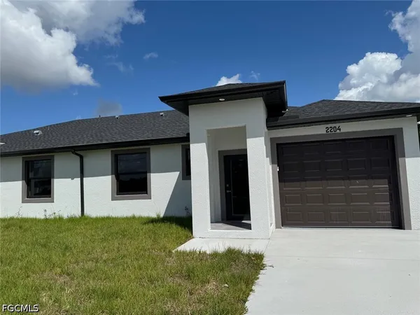 a front view of a house with garage